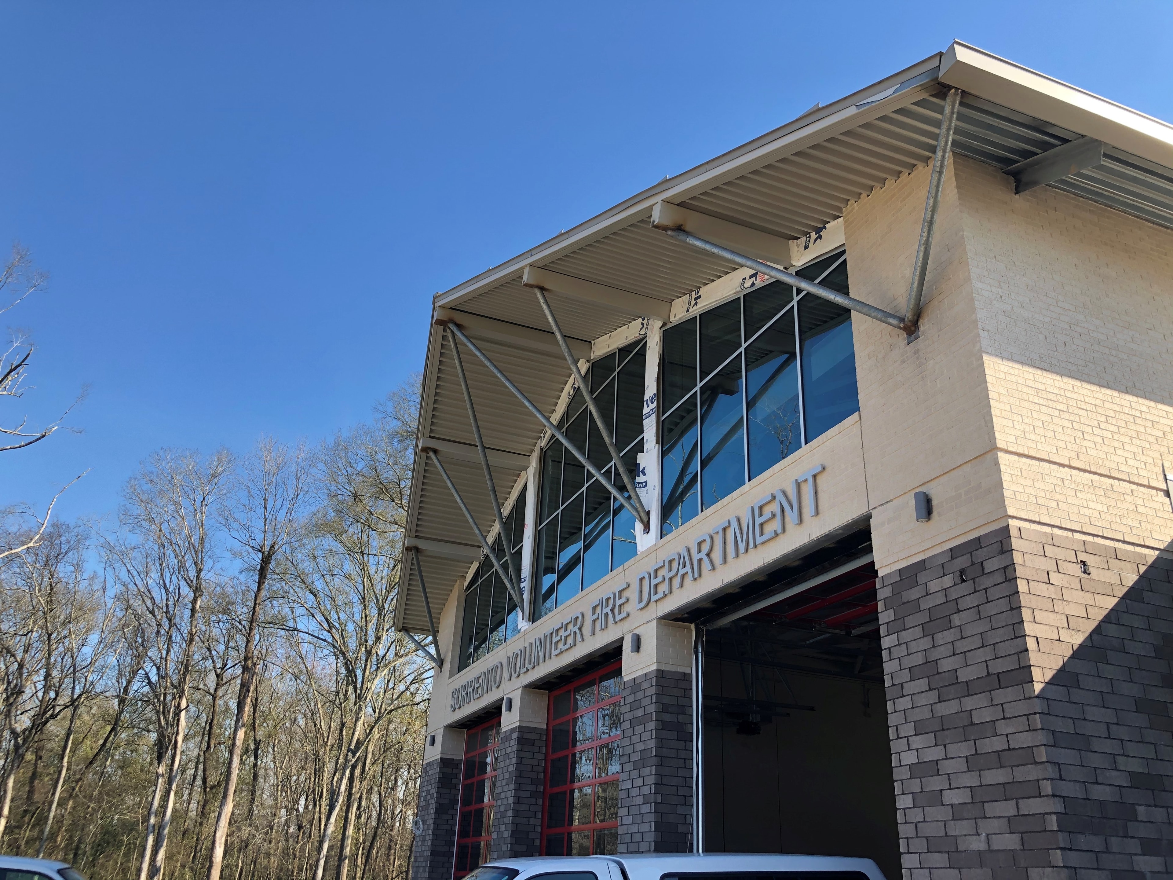 Fire Station 20 exterior showing structural steel trusses and decking over engine bay entrance