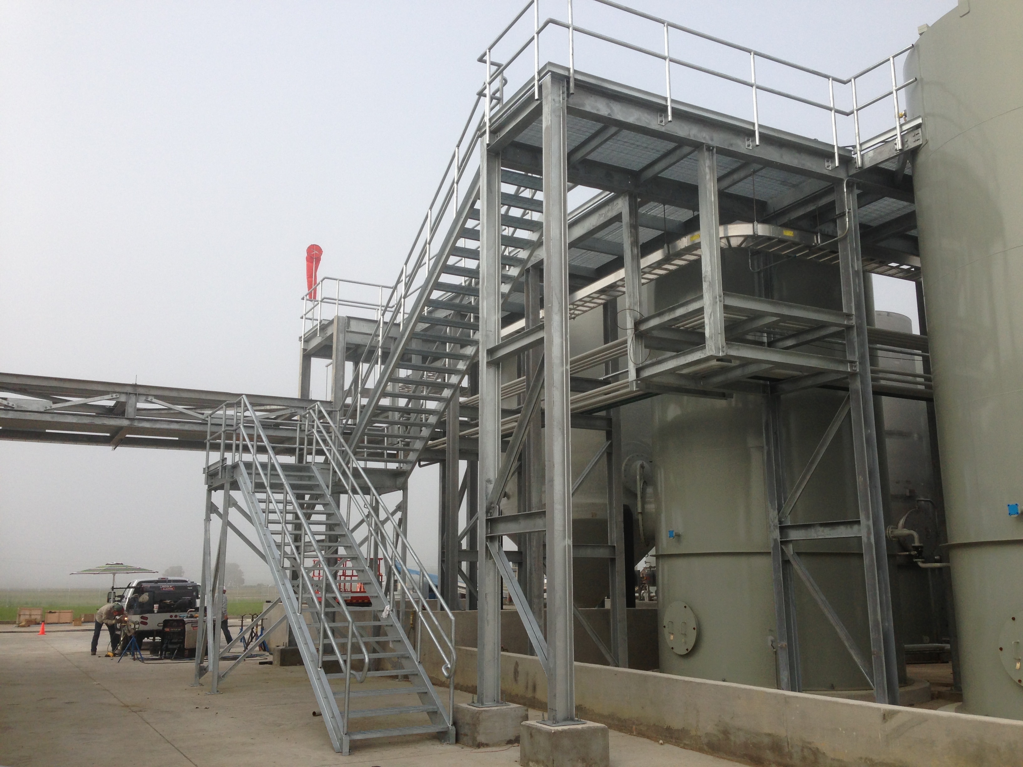Halliburton multi-level galvanized stair tower at tank farm exterior