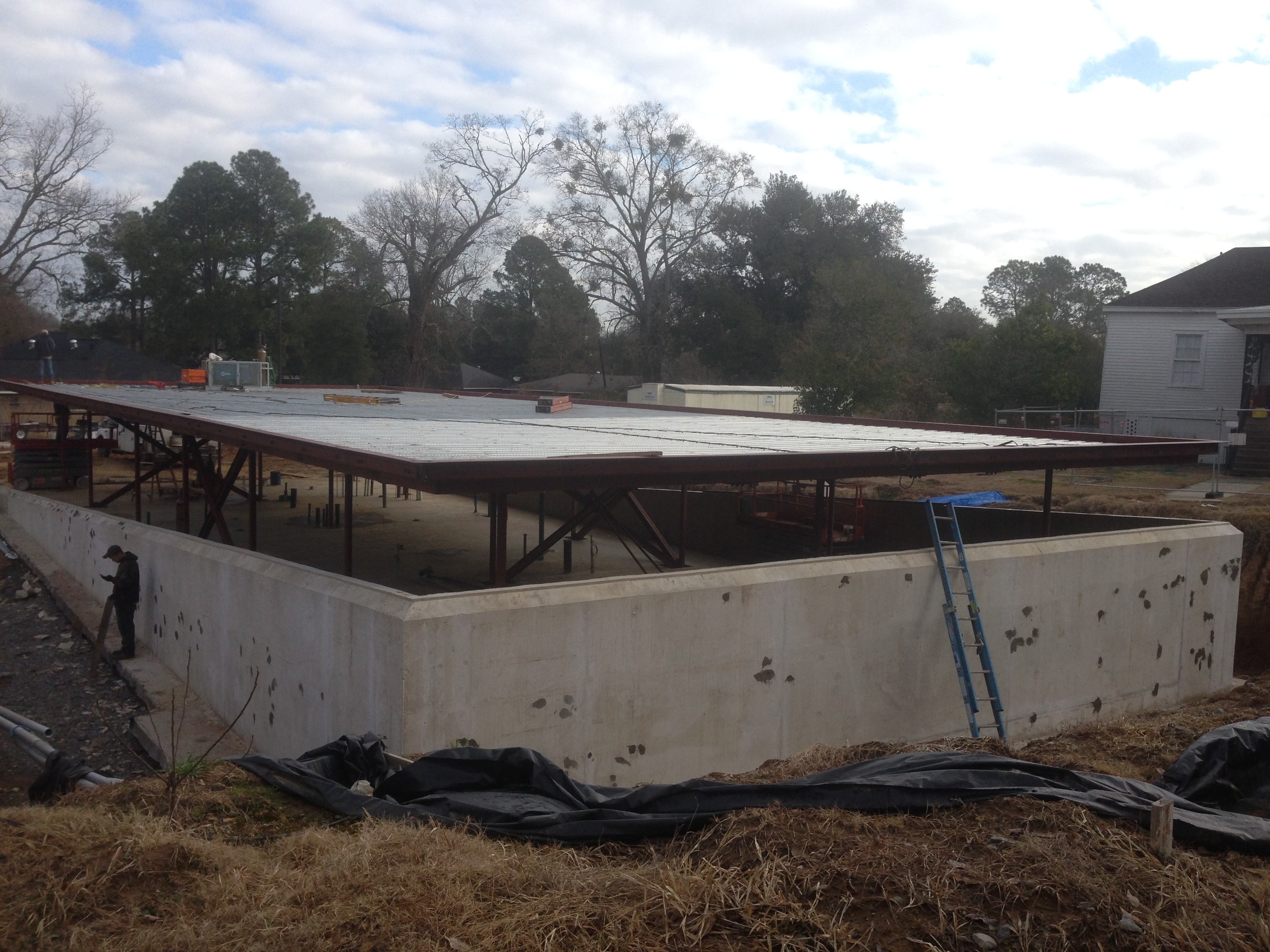 Magnolia Mound structural steel frame with completed metal decking over concrete foundation
