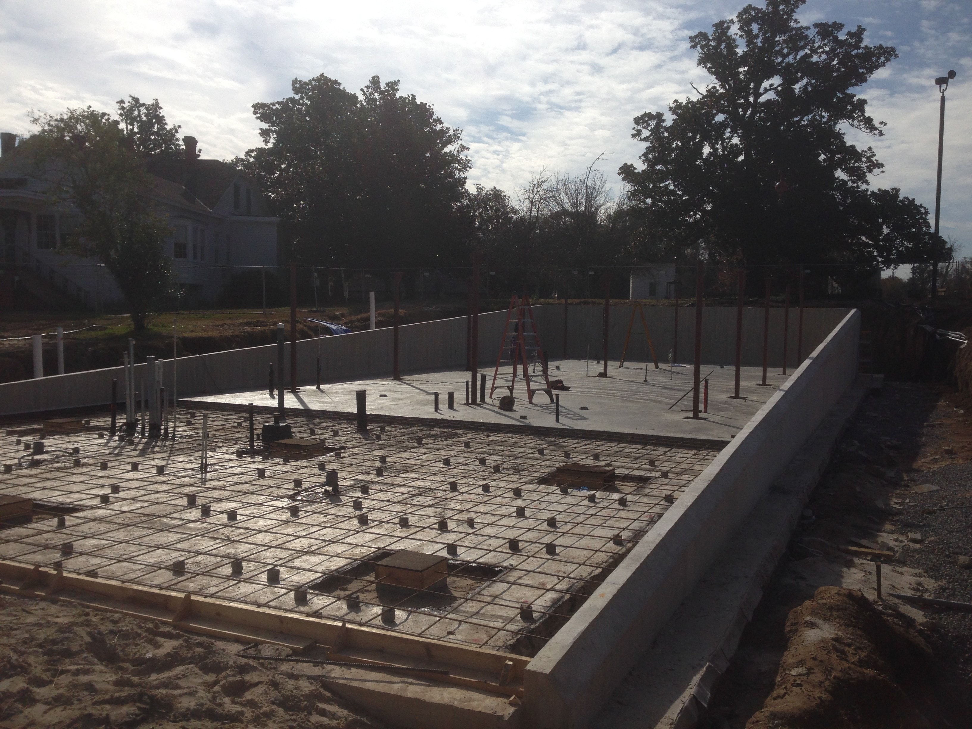 Magnolia Mound early construction showing concrete foundation walls and anchor bolt layout