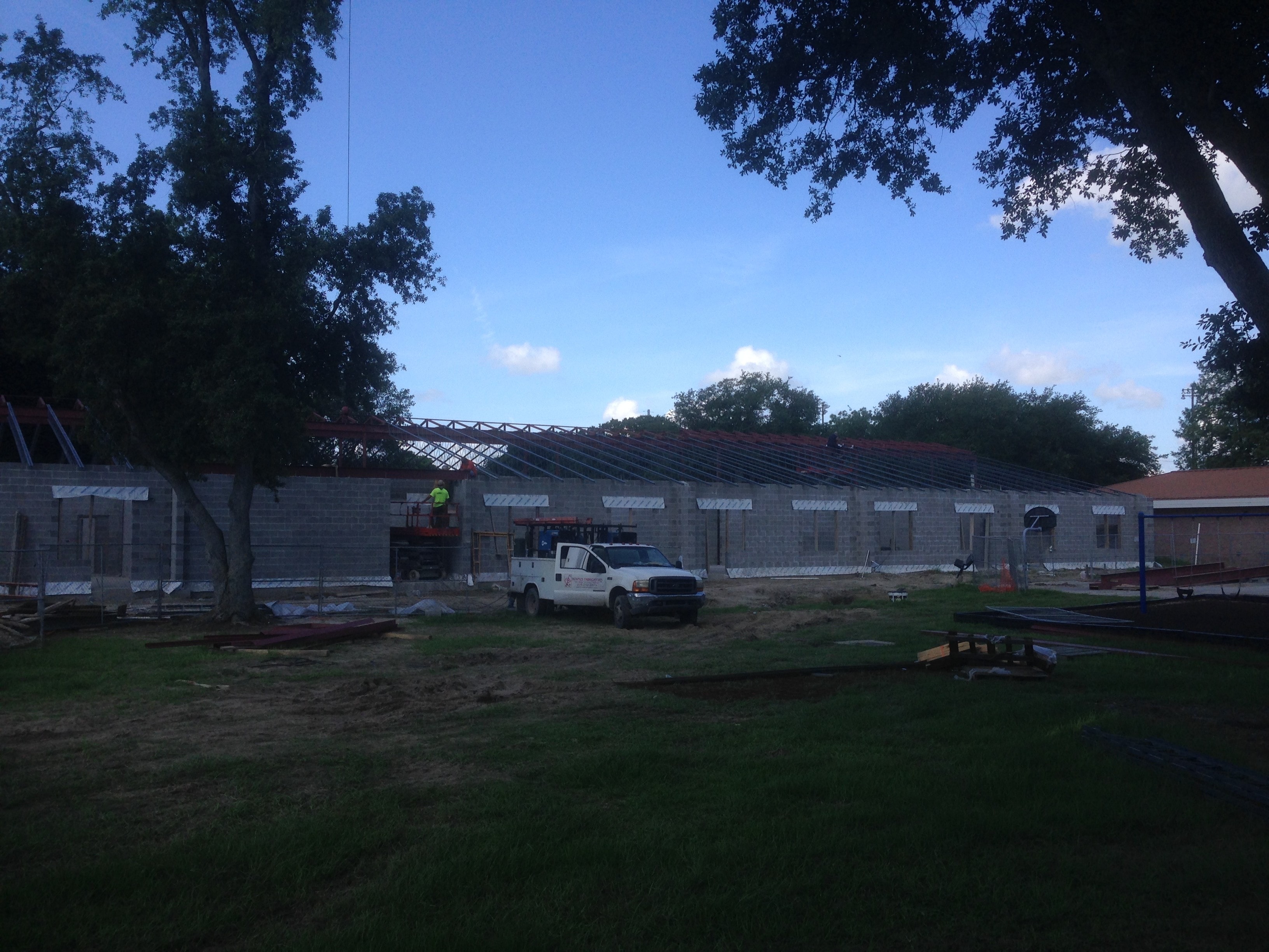 Norco Elementary Addition — exterior view of CMU walls with bar joist and roof framing at dusk