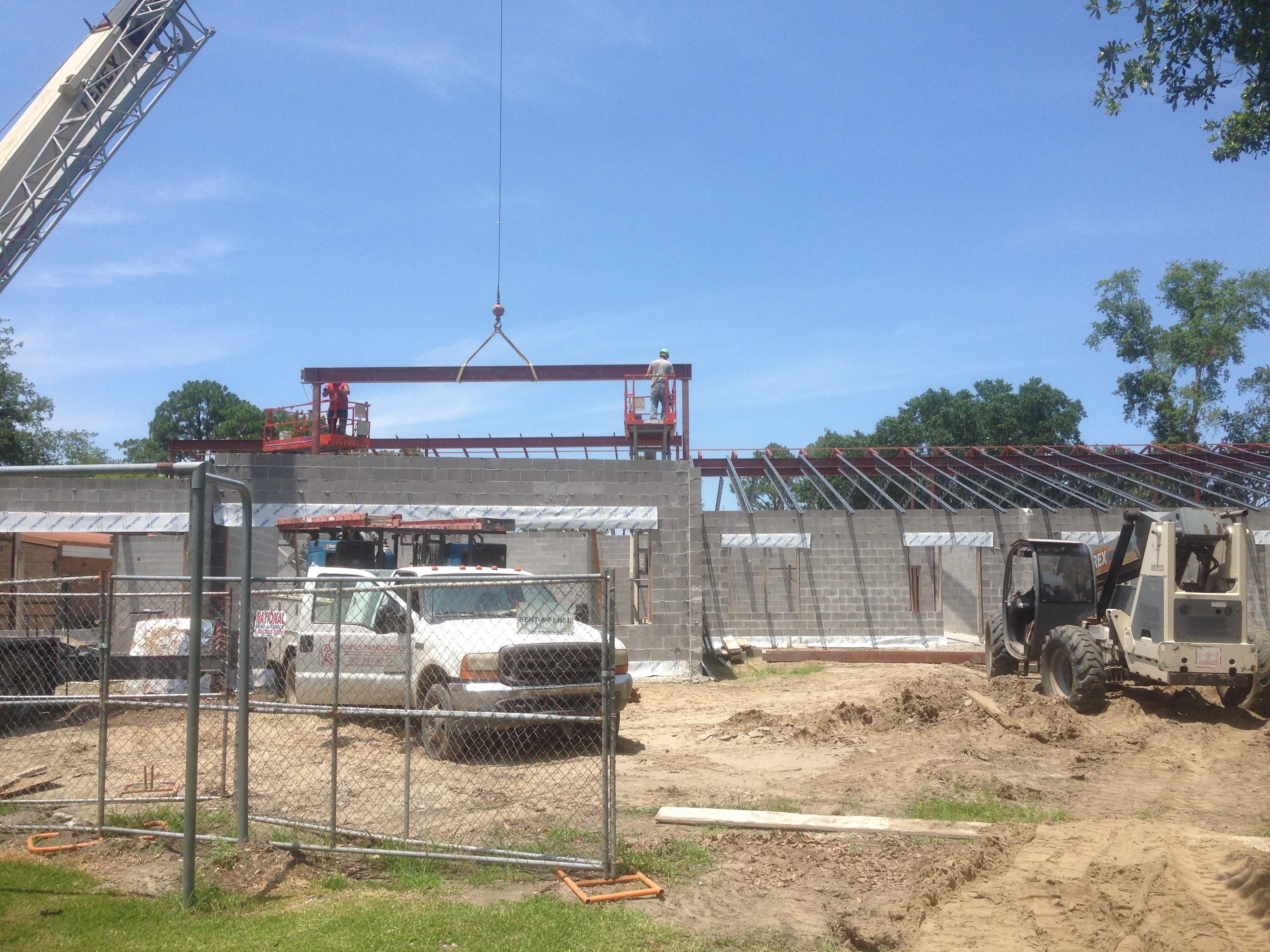 Norco Elementary Addition — crane hoisting beam with workers on aerial lifts and Terex on site