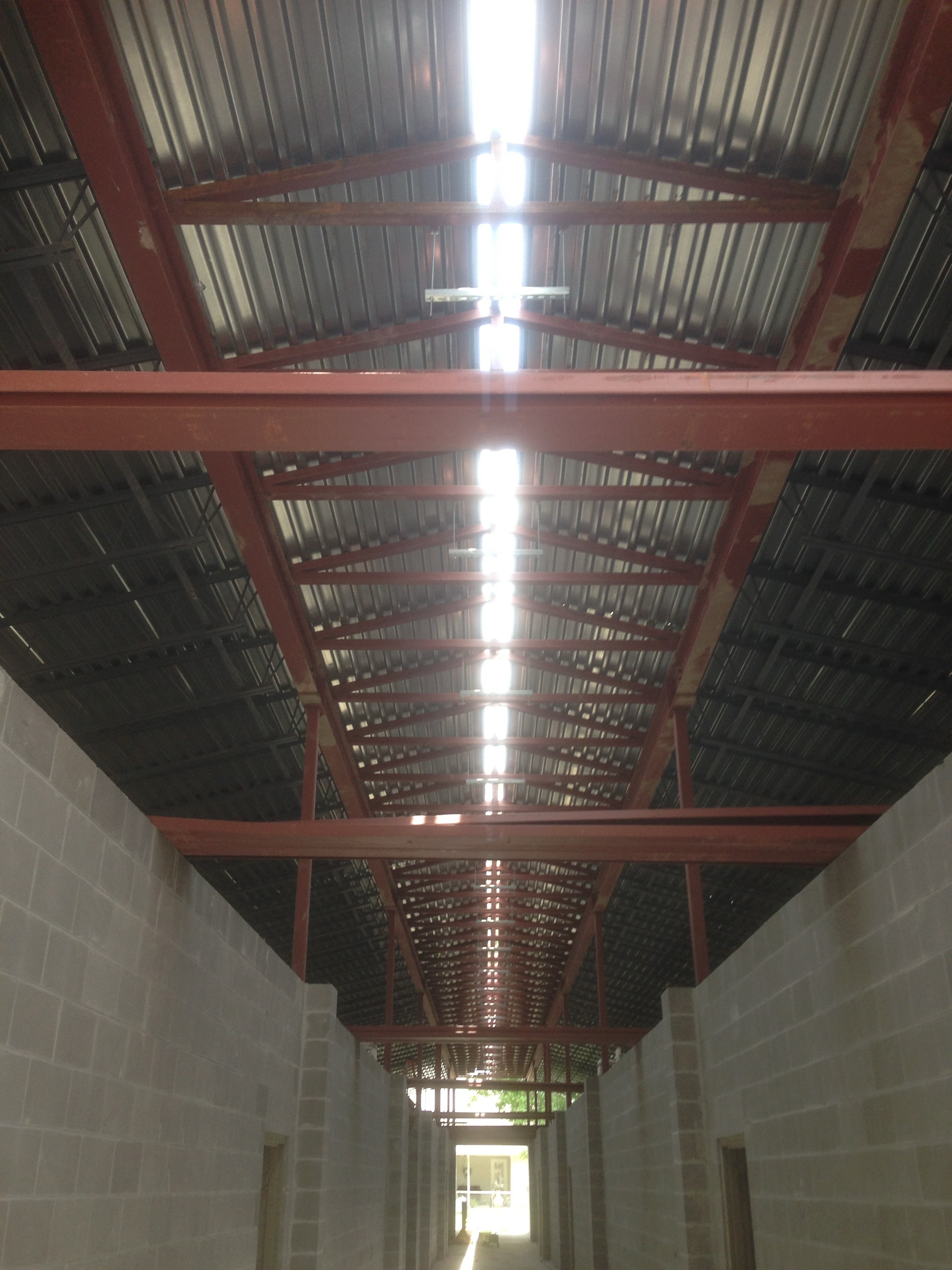 Norco Elementary Addition — interior corridor view of red steel trusses and bar joist decking