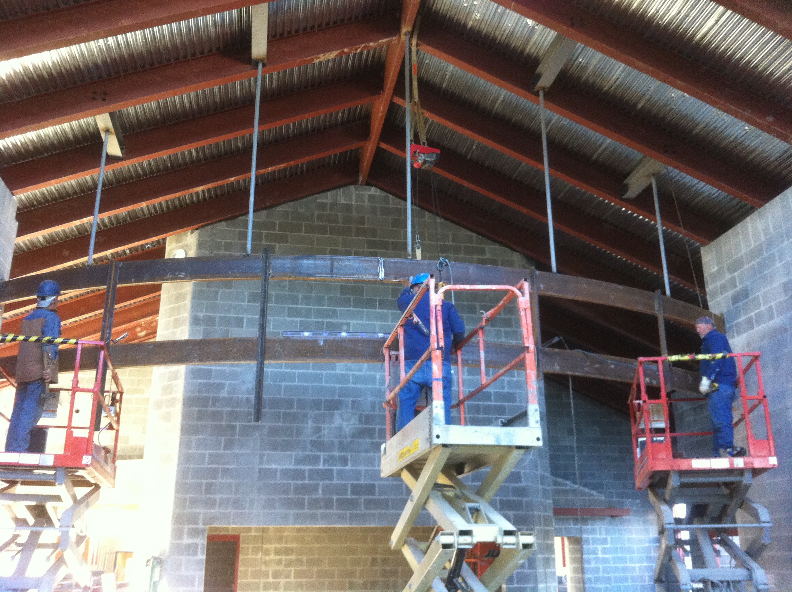 St. Amant High School construction workers on elevated steel framing
