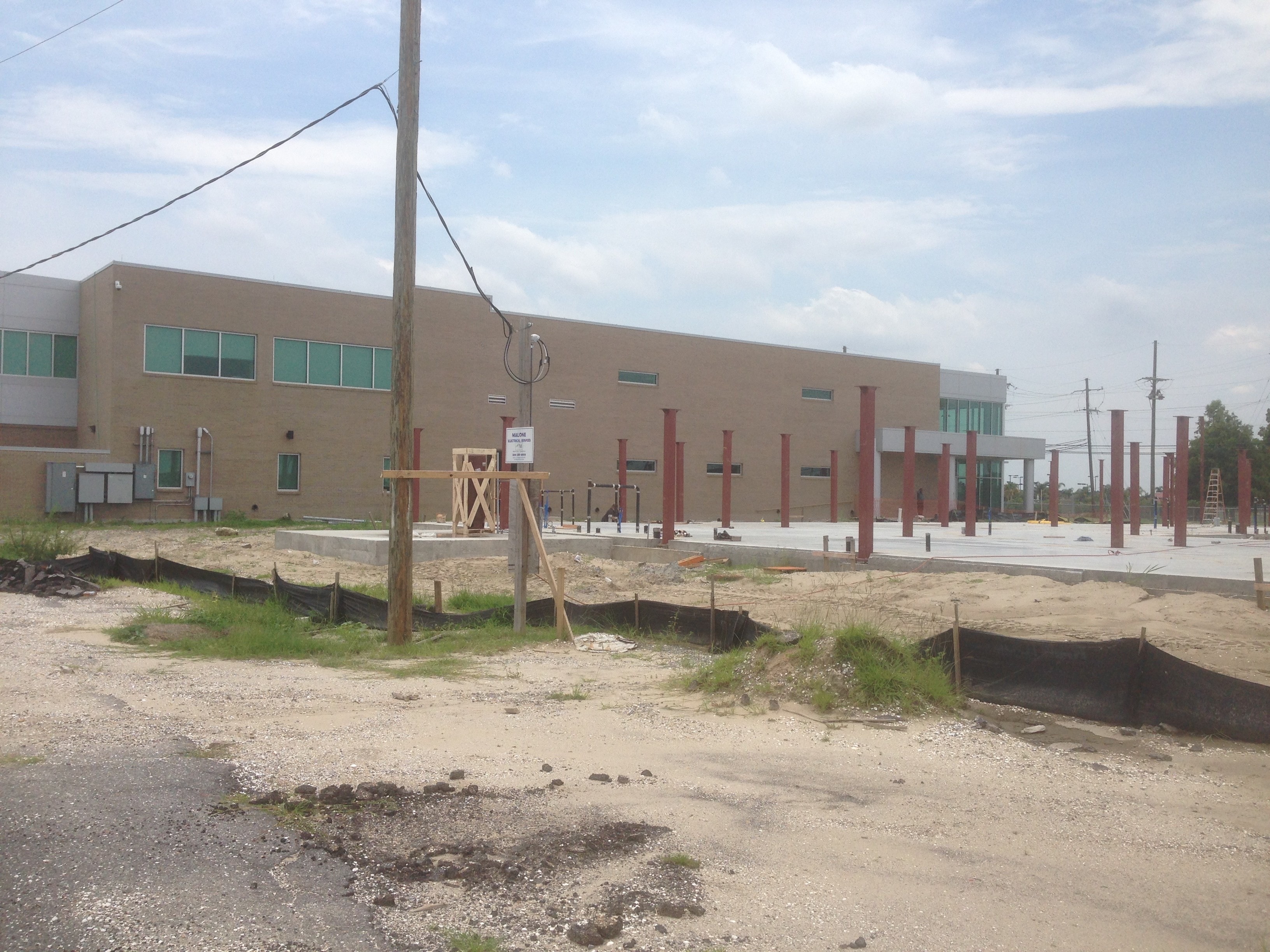 USF Business & Admin Building Addition — steel columns and red support pillars with existing building