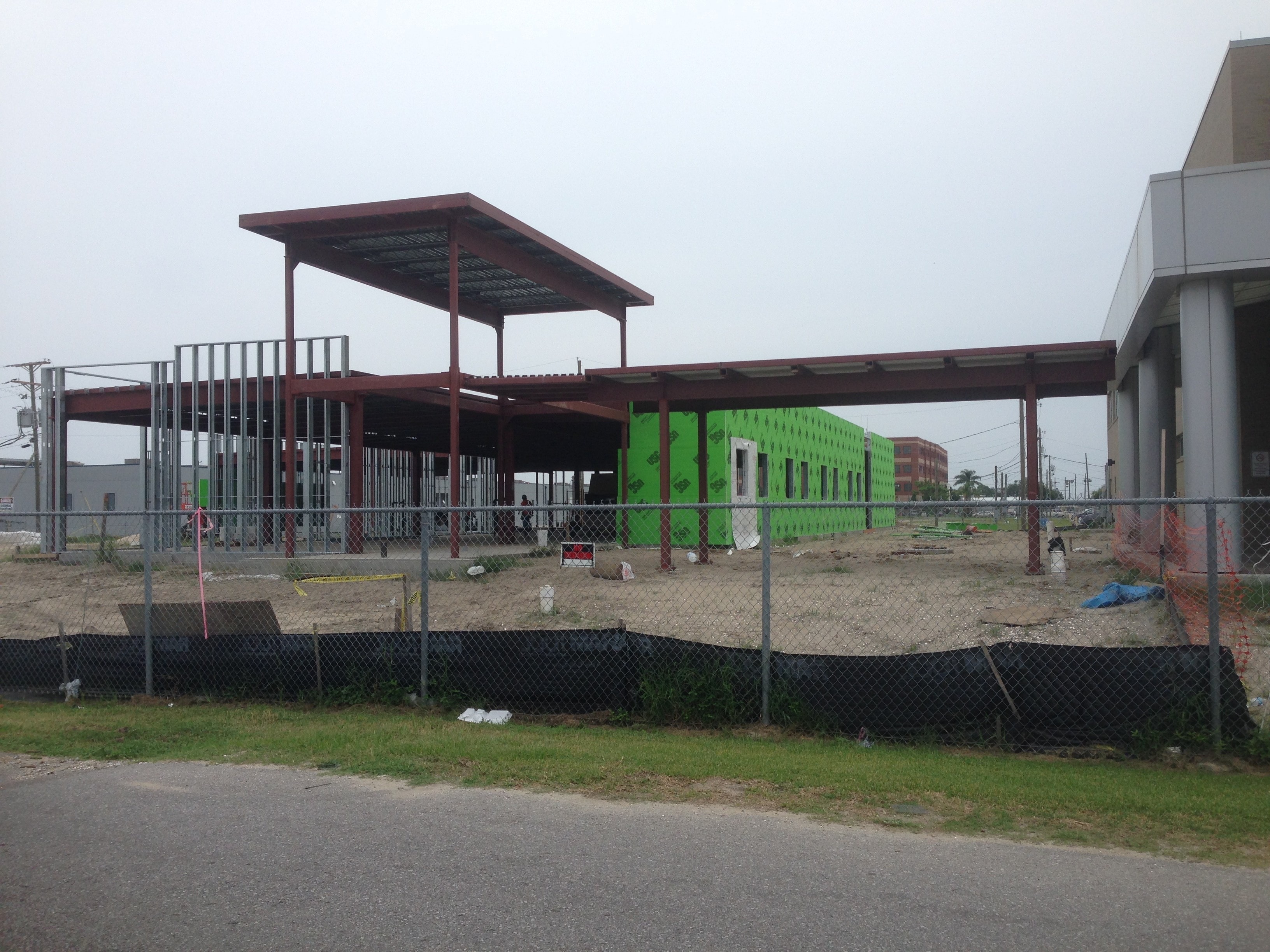 USF Business & Admin Building Addition — completed canopy steel and green building wrap from street
