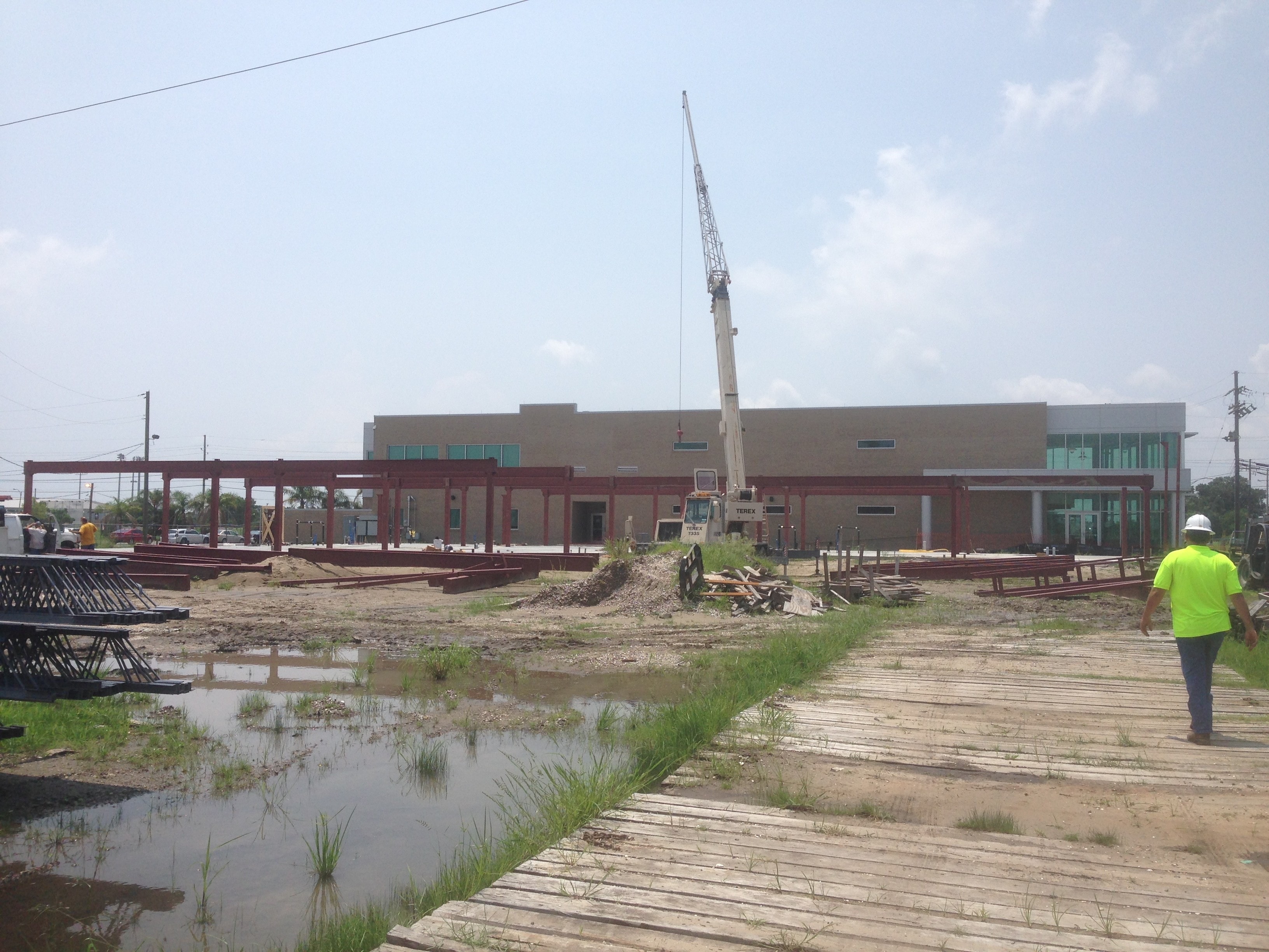 USF Business & Admin Building Addition — wide site view with crane and steel frame taking shape