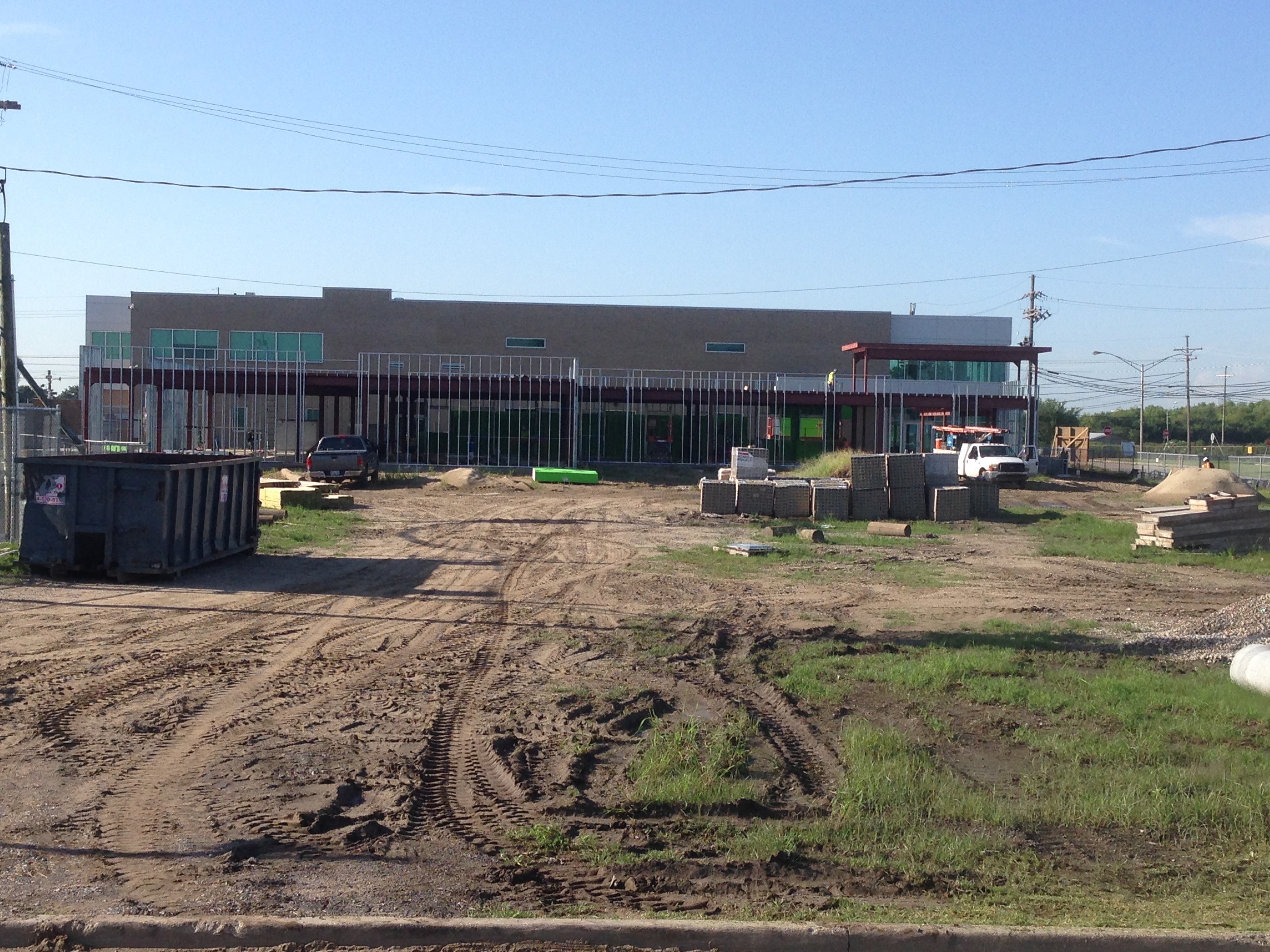 USF Business & Admin Building Addition — steel frame and green building wrap with canopy framing