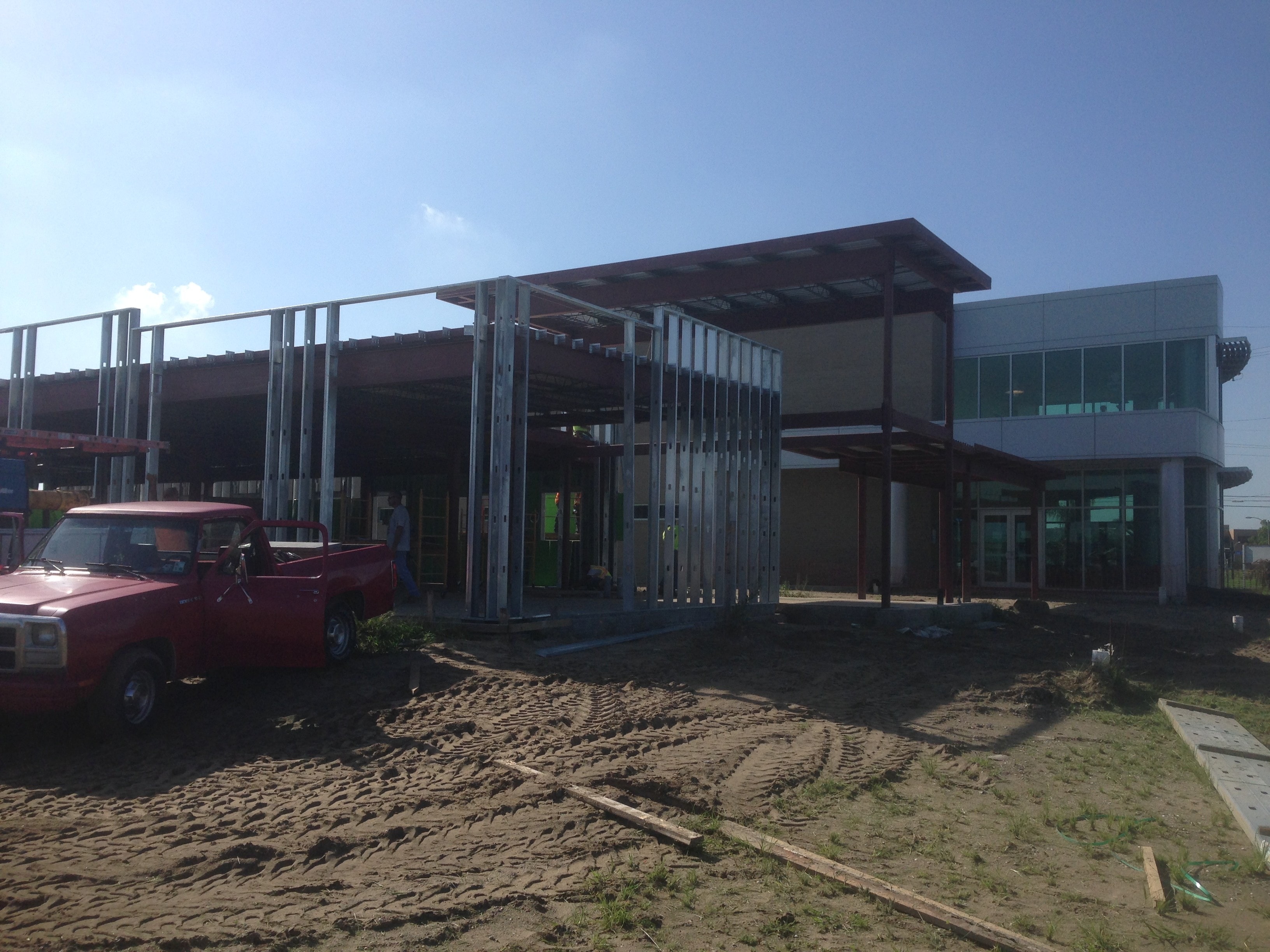 USF Business & Admin Building Addition — canopy steel and stud framing with red truck in foreground